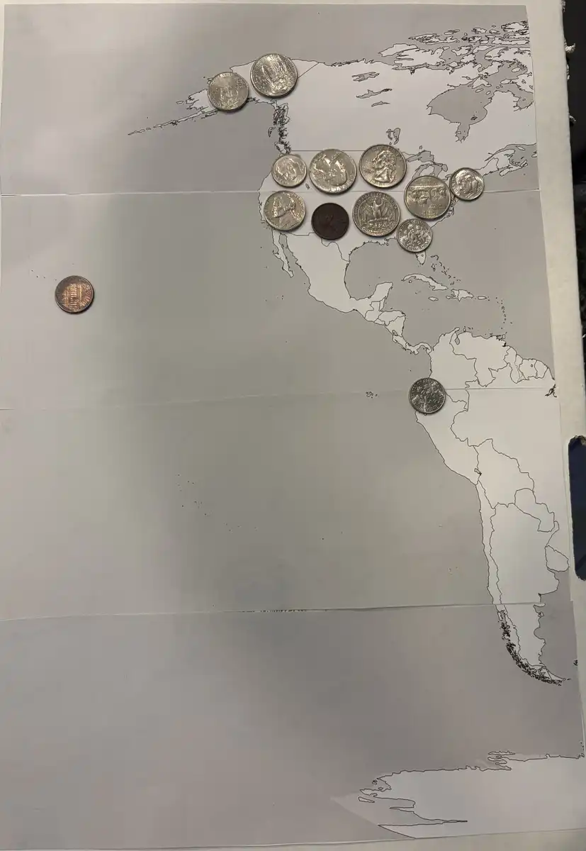 Working-On-A-World-Map-Made-Of-Coins.