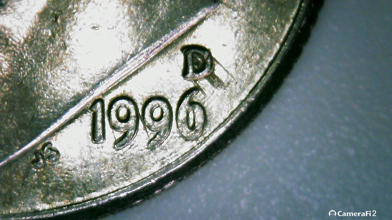 Writing-Of-Some-Kind-Along-The-Bridge-Of-His-Nose-1996-D-Dime