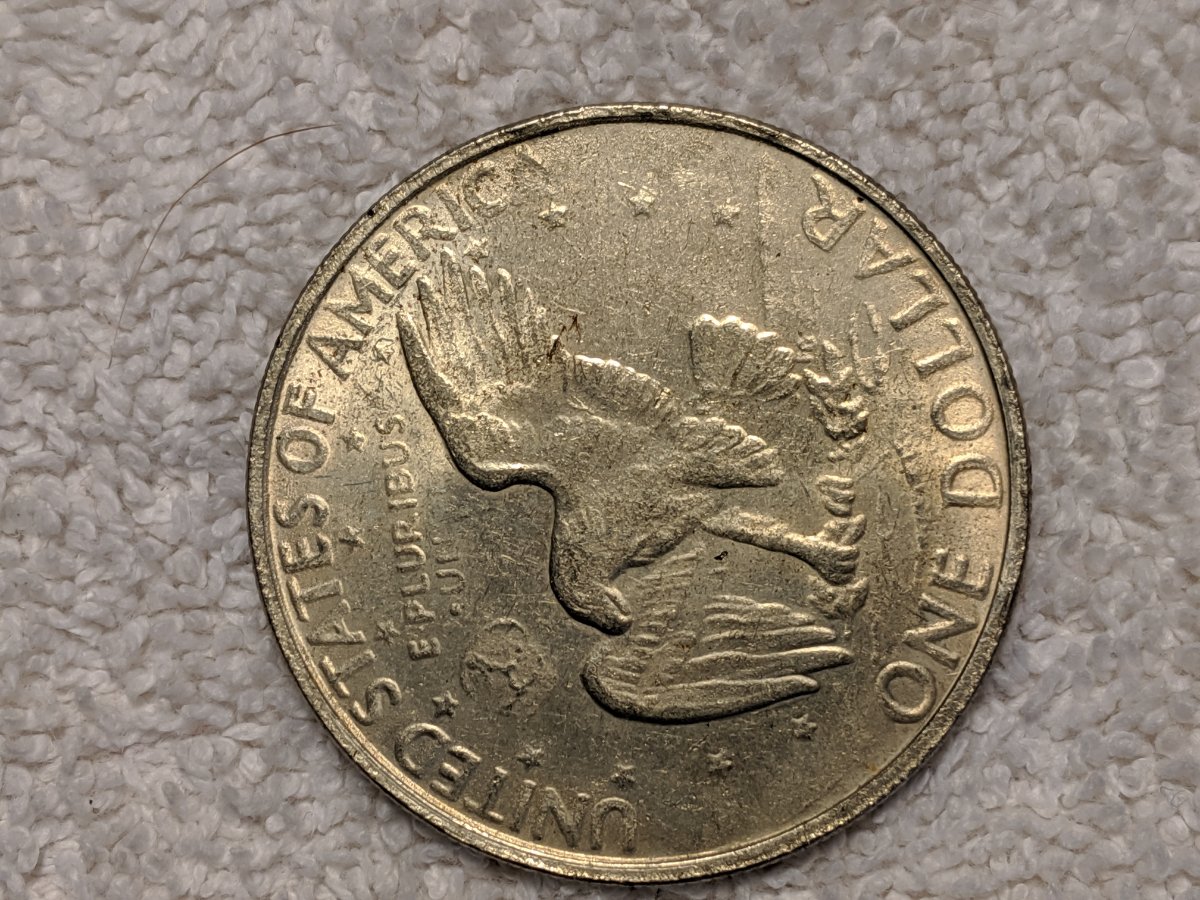 1977-S-Dollar-Silver-One-Legged-Eagle,-Struck-Through-Grease?