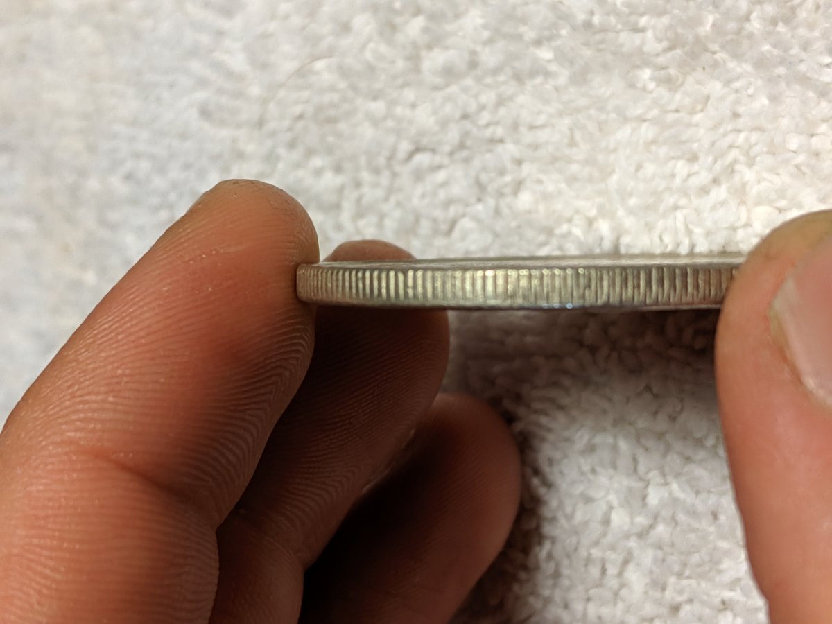 1977-S-Dollar-Silver-One-Legged-Eagle,-Struck-Through-Grease?