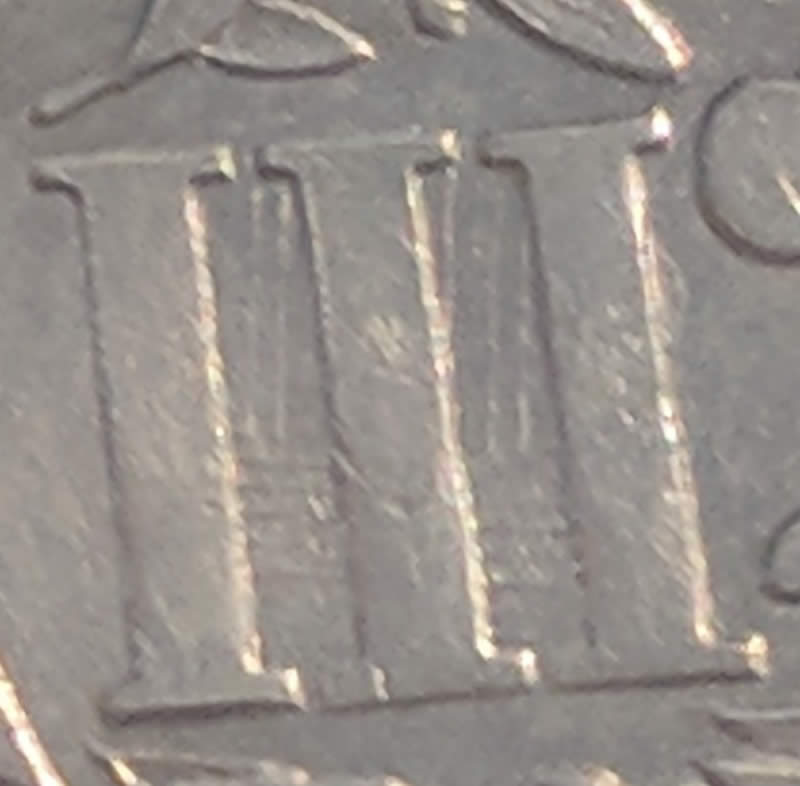 Help!-Very-Nice-Silver-Trime-With-What-Looks-Like-A-Strike-Through.
