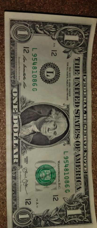 2013-Dollar-Bill-Looks-Like-Thread-Is-Through-Face