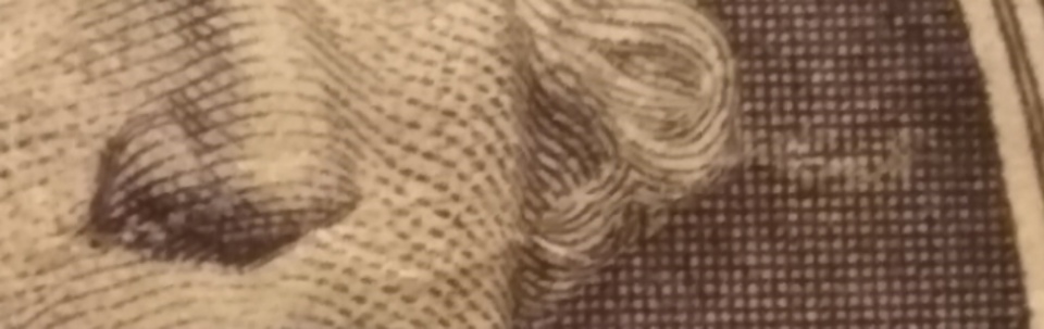 2013-Dollar-Bill-Looks-Like-Thread-Is-Through-Face