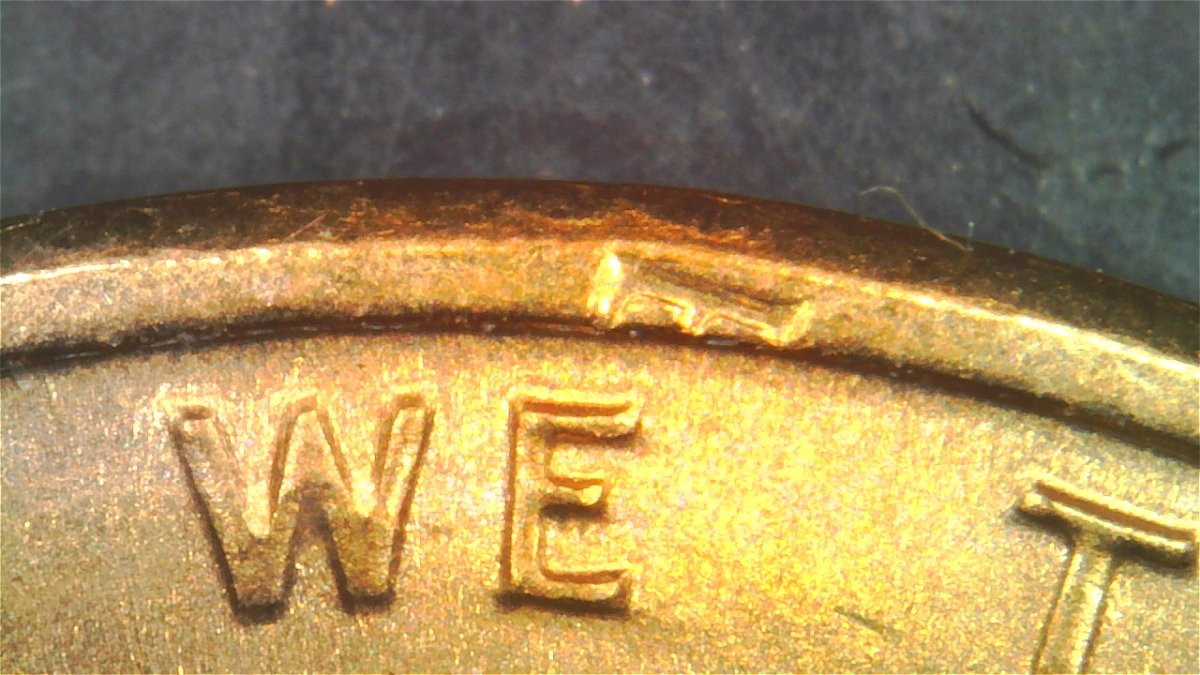 1983-LMC-Extra-Partial-E-On-Rim-Of-We-On-Obverse
