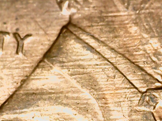 What-Causes-These-Lines-To-Form-On-A-Coin?-And-Why-Do-They-Show-Up-Kinda-Black-To-The-Naked-Eye?