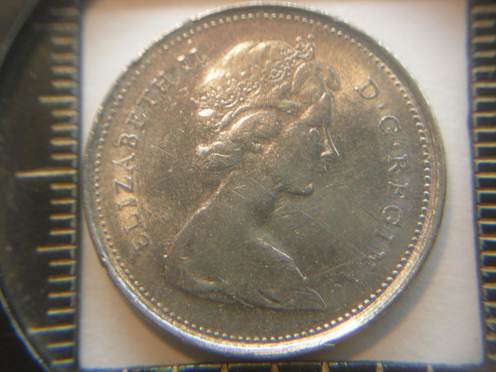 1975-Quarter-On-1966-5-Cents;-What?