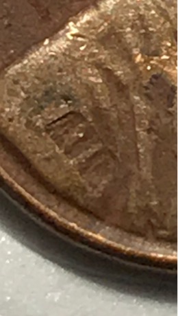 1957-D-Wheat-Penny-With-Another-Coin-Print-Over-Top?
