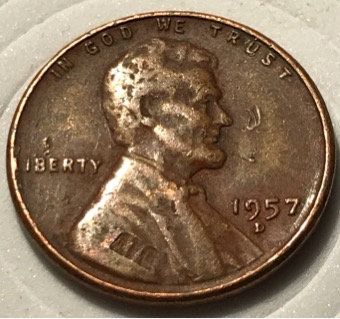 1957-D-Wheat-Penny-With-Another-Coin-Print-Over-Top?