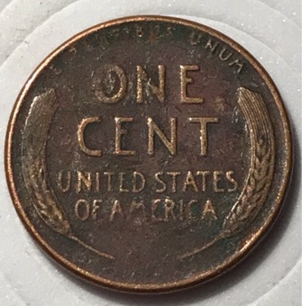 1957-D-Wheat-Penny-With-Another-Coin-Print-Over-Top?