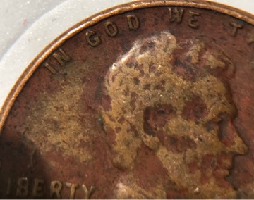 1957-D-Wheat-Penny-With-Another-Coin-Print-Over-Top?