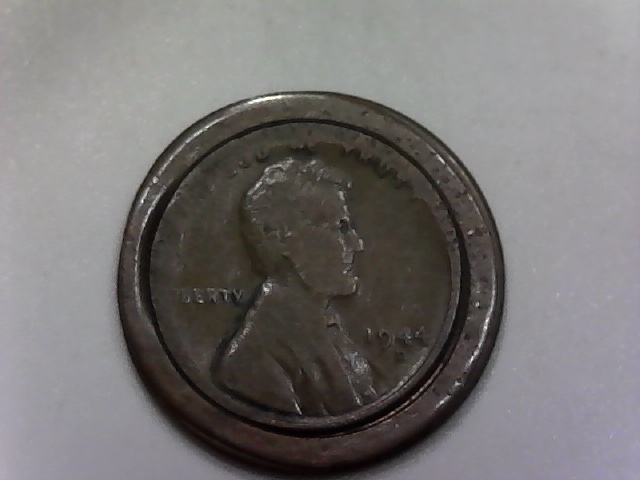 Three-Lincoln-Cents-Struck-Off-Center-And-One-?-Jewelry-Piece?
