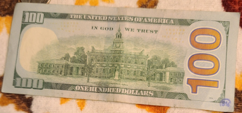 100-Dollar-Bills-With-Small-Ink-Stamps-On-The-Reverse
