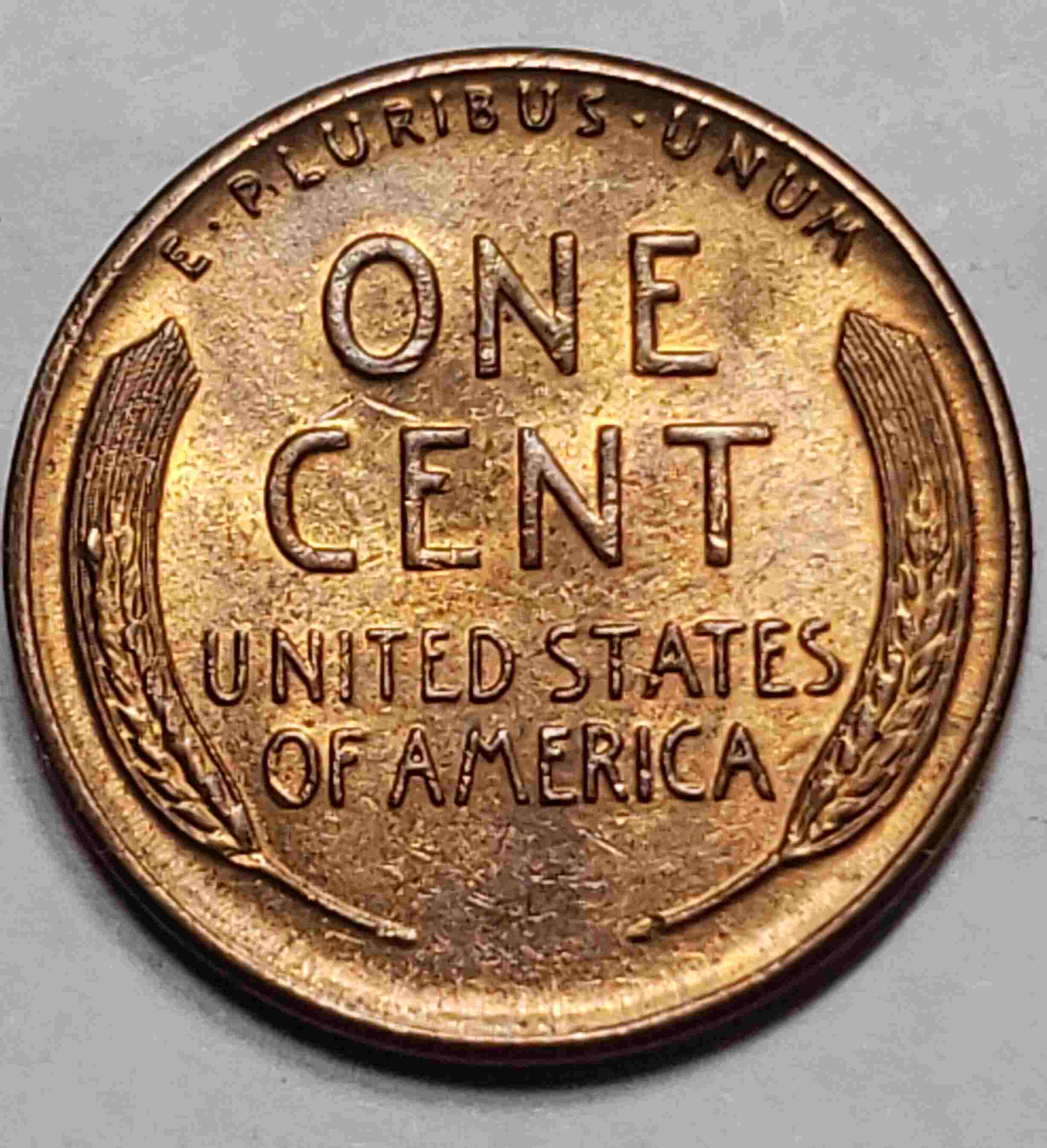 1955-1-Cent.-Slight-Raise-In-Left-Wheat.-Indentation-On-Lincoln-Head.-Any--Info/Cause?