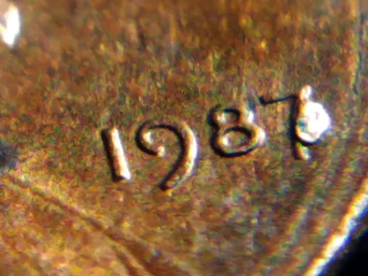 1987-Penny-With-Melted-Dot-Next-To-7.