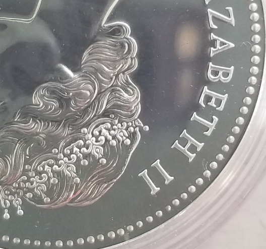 1976-Dollar-With-Varying-Sizes-Of-Beads-On-Rim