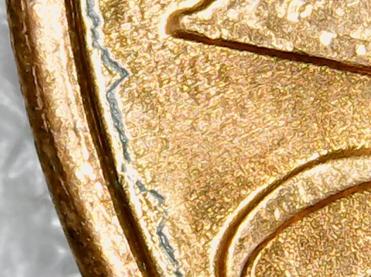 Penny-With-Raised-Half-Circle-Going-Thru-In-God-We-Trust