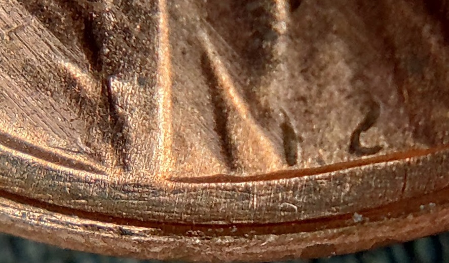 1983-P-Lincoln-Cent-With-A-Secondary,-Incuse-&-Inverted,-Trust-In-The-Corner-Of-The-Rim-And-Field.
