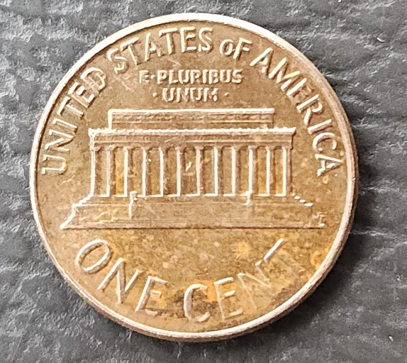 1964-D-Penny-Obverse-In-God-We-Trust-Rolled-Up-On-Rim-Halfway