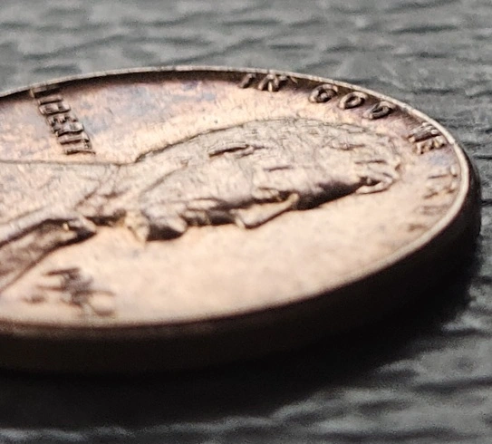 1964-D-Penny-Obverse-In-God-We-Trust-Rolled-Up-On-Rim-Halfway