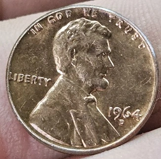 1964-D-Penny-Obverse-In-God-We-Trust-Rolled-Up-On-Rim-Halfway