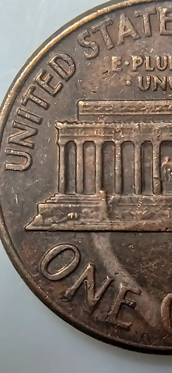 1970-Lincoln-Penny-With-Unknown-Design-In-Front-Of-The-Portrait.