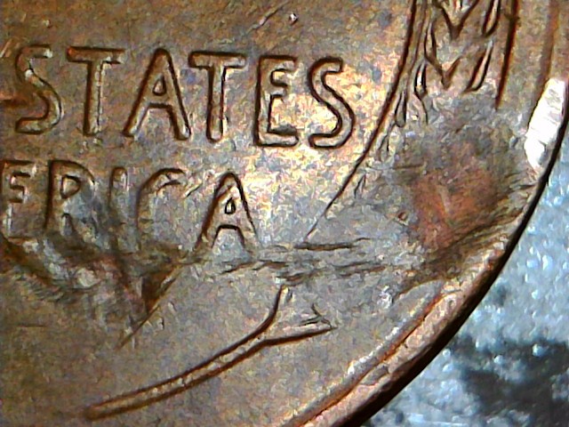 1957-D-Bie,-Plus-Struck-Thru-Debris,-Plus-Lamination,-Plus-Struck-Thru?