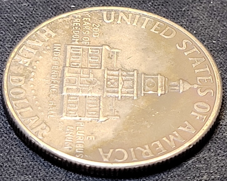 1976-D-Kennedy-Half-Dollar-With-A-Big-O-Bubble-On-The-Obverse
