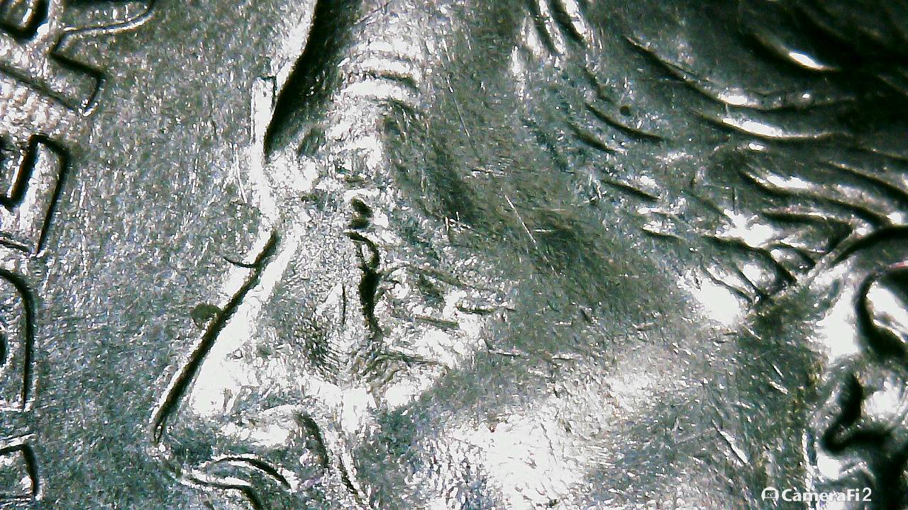 Writing-Of-Some-Kind-Along-The-Bridge-Of-His-Nose-1996-D-Dime