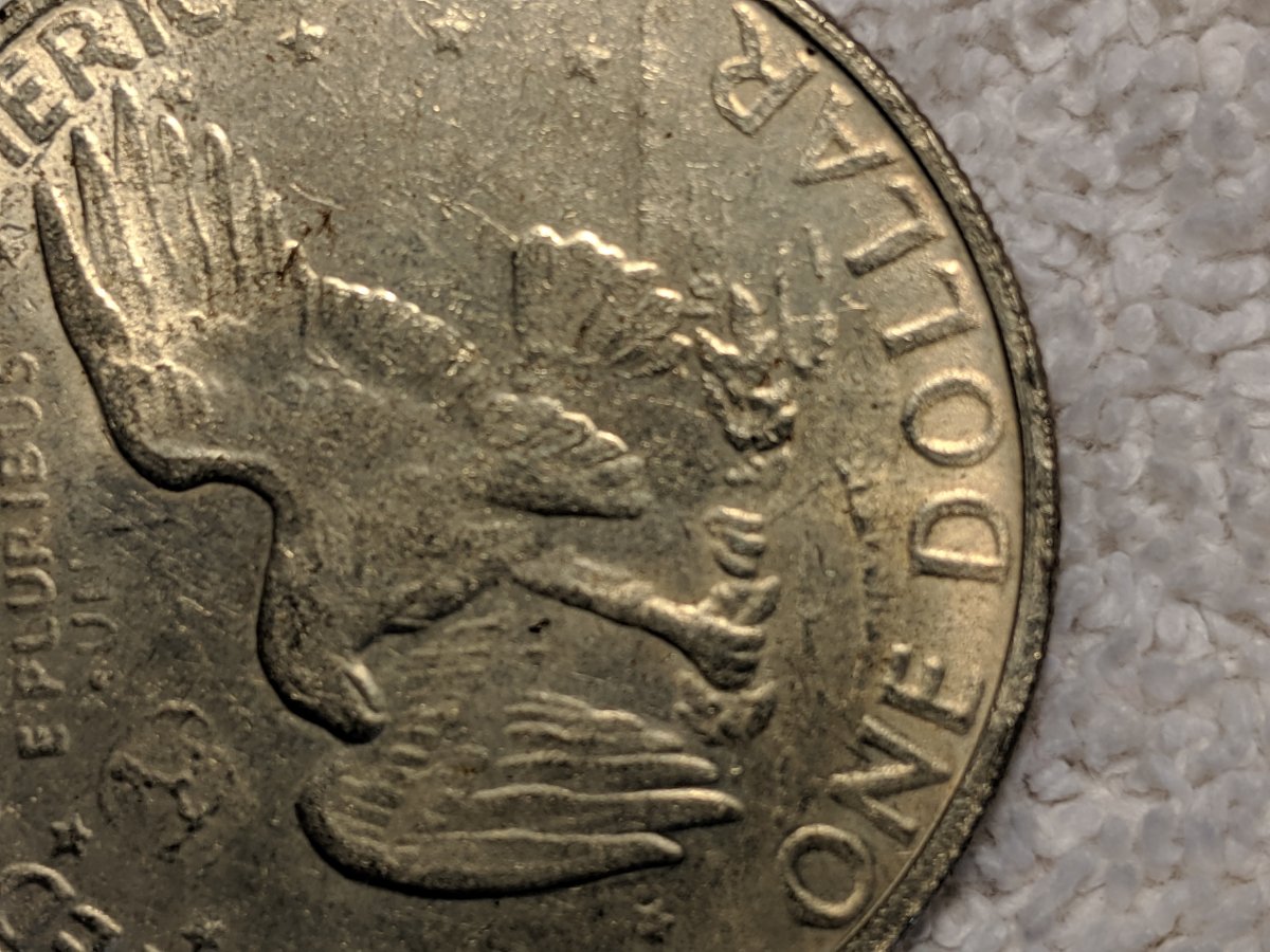 1977-S-Dollar-Silver-One-Legged-Eagle,-Struck-Through-Grease?