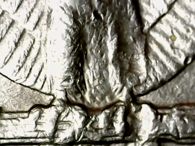 1987-D-Quarter-With-Strange-Right-Leg-On-Eagle