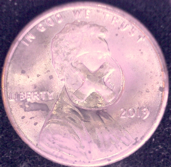 Is-This-Something-Struck-Through-This-Penny?-A-Button?