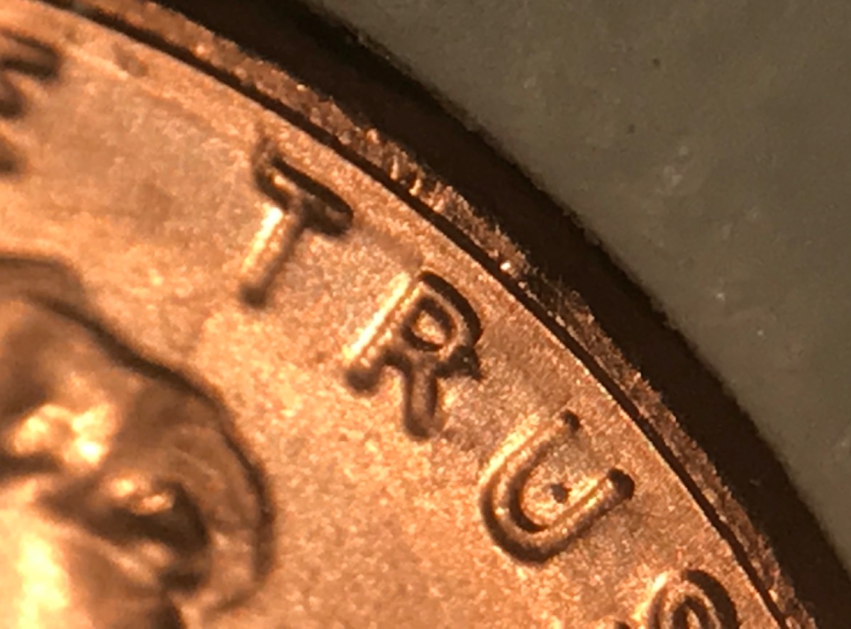 What-Causes-This-Metal-Movement-Near-Rim-Of-This-Cent?
