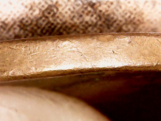 1957-D-LWC-Struck-Through-Debris-Or-Just-Lamination-Issue?