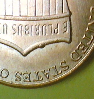 2014-Penny-With-Die-Chip-On-Top-Of-Shield