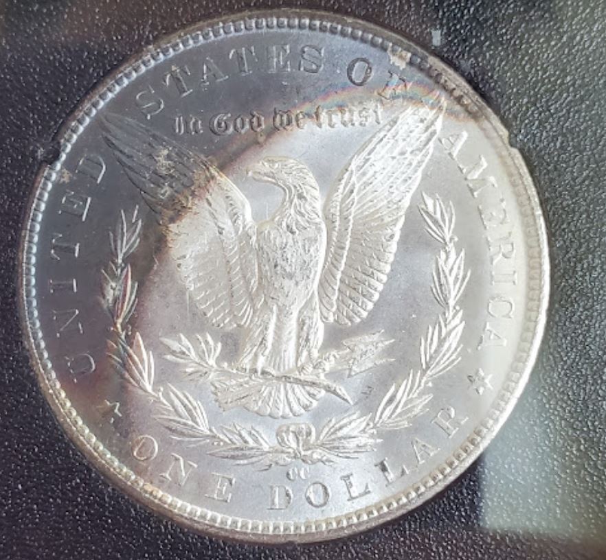 1884-CC-Morgan,-Crescent-Toning.-GSA-Holder-For-Grading.