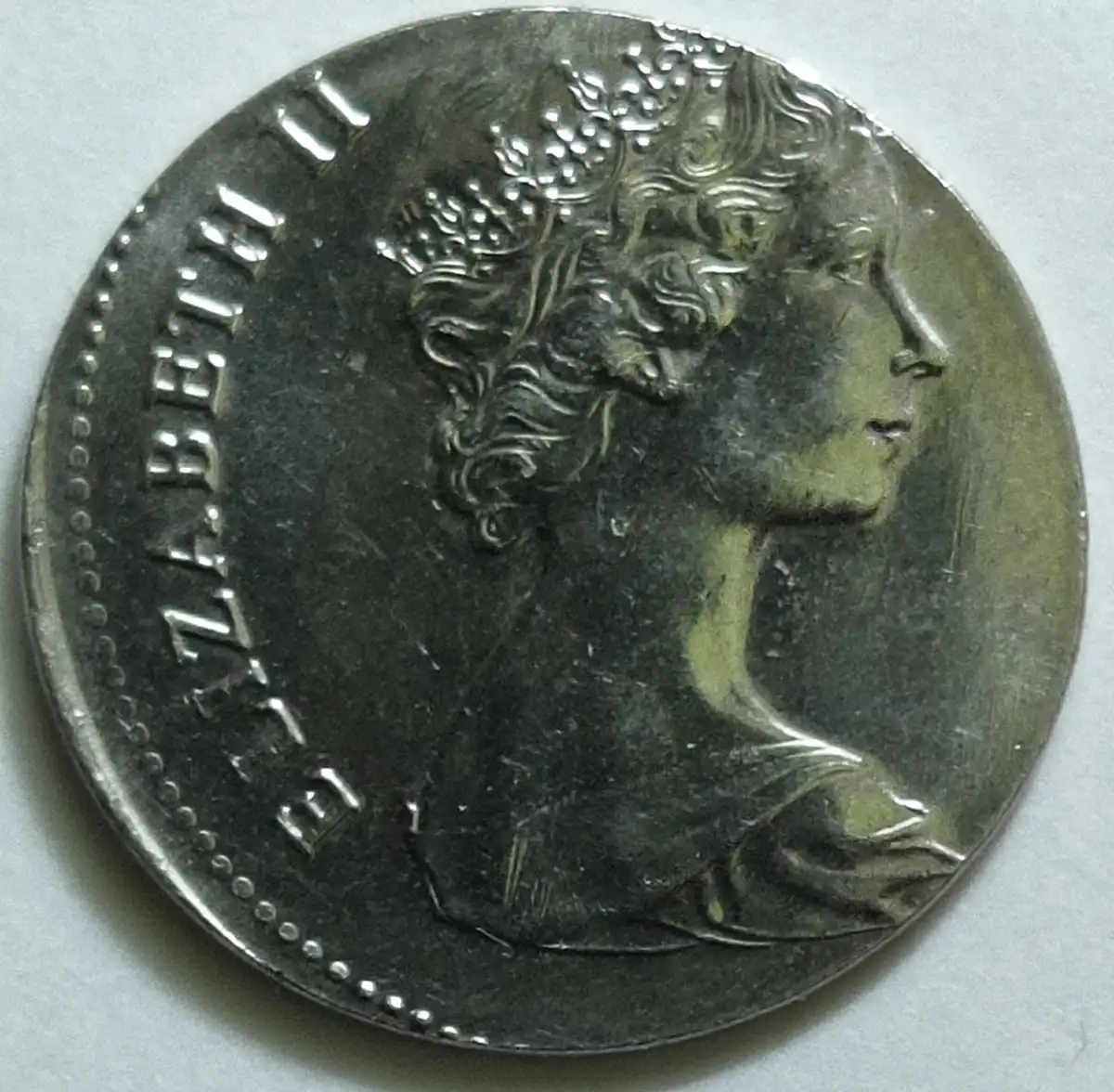 1980-25-Cent-Coin-On-A-10-Cent-Planchette?