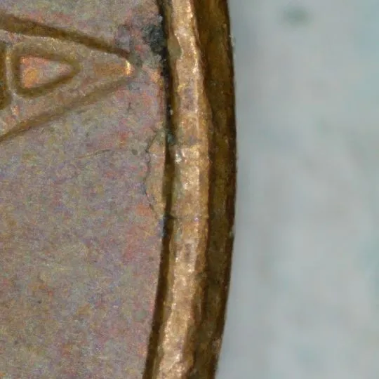 1977-LMC-Penny-/-Struck-Thru-Foil.-Retained-Break,-Or-Fin-Fold-Over?