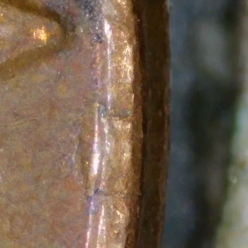 1977-LMC-Penny-/-Struck-Thru-Foil.-Retained-Break,-Or-Fin-Fold-Over?