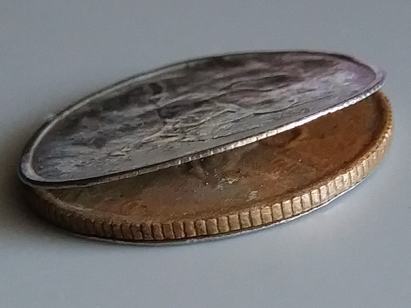 Peeling-Clad-Layer-On-Deleware-State-Quarter?