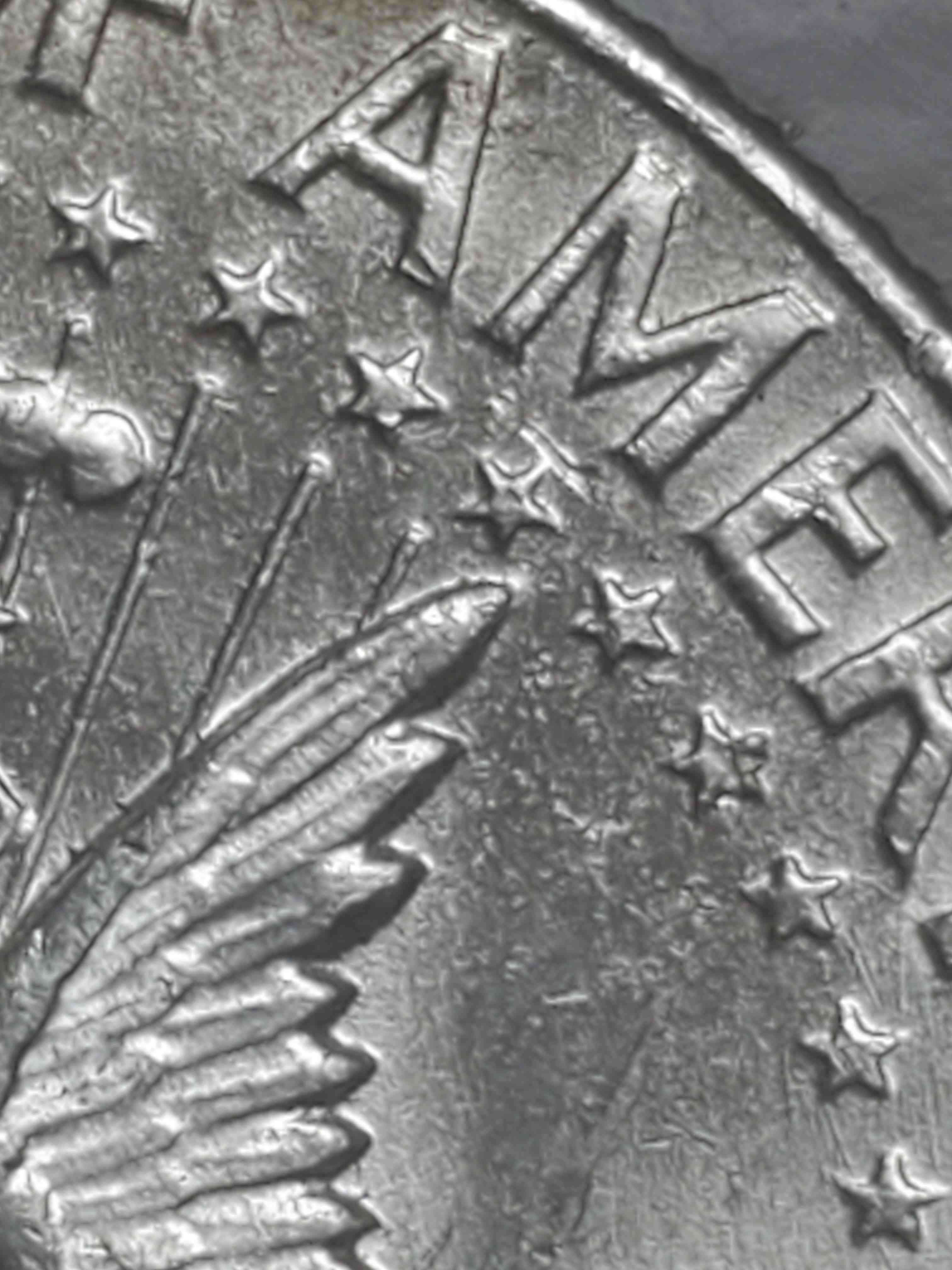 1964-Kennedy-Half-Dollar.-There-Is-An-Error-Below-The-M-In-America.--What-Is-It