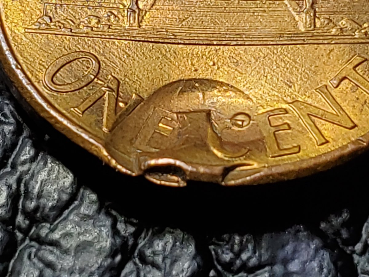 Is-This-Something-Struck-Through-This-Penny?-A-Button?