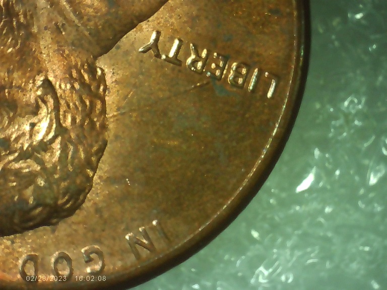 1990-P-Red-Penny-With-Long-Die-Break-On-Front-Going-From-E-Thru-His-Head