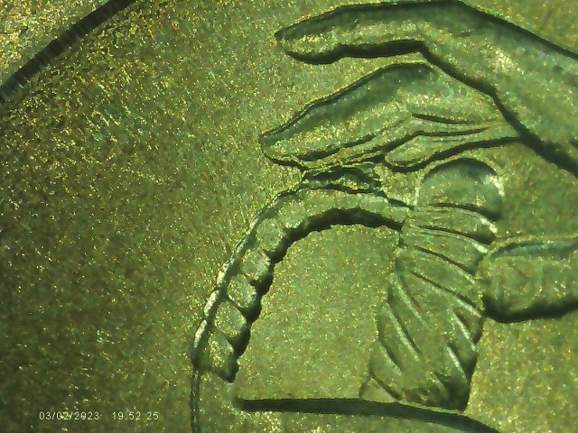 2015-Quarter-With-Die-Chip-Between-Finger-&-Sword-Handle
