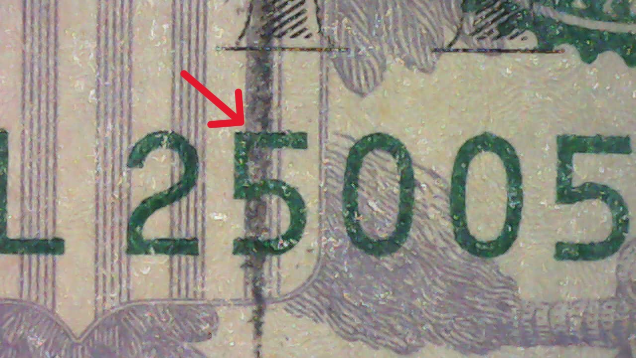 Black-Spear-Through-US-$5-Bill