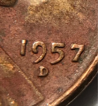 1957-D-Wheat-Penny-With-Another-Coin-Print-Over-Top?