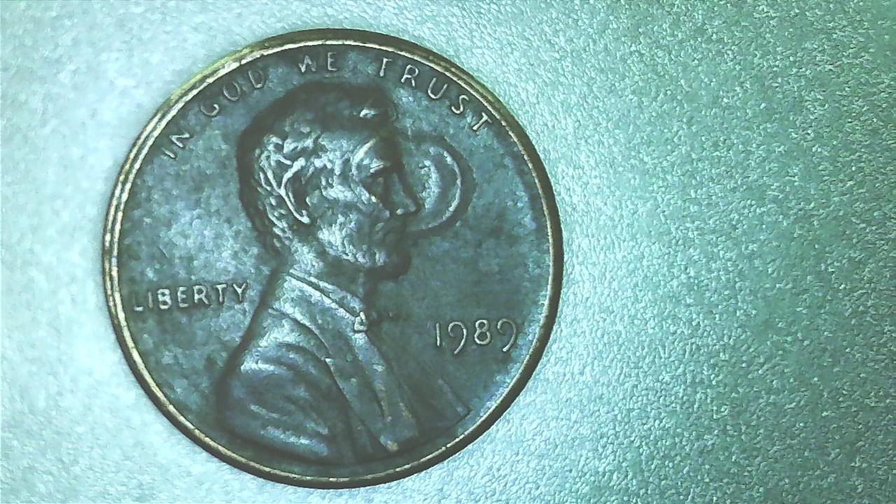 1989-No-Mint-Lincoln-Cent-W/-Remnants-Of-Unknown-Object-In-Face