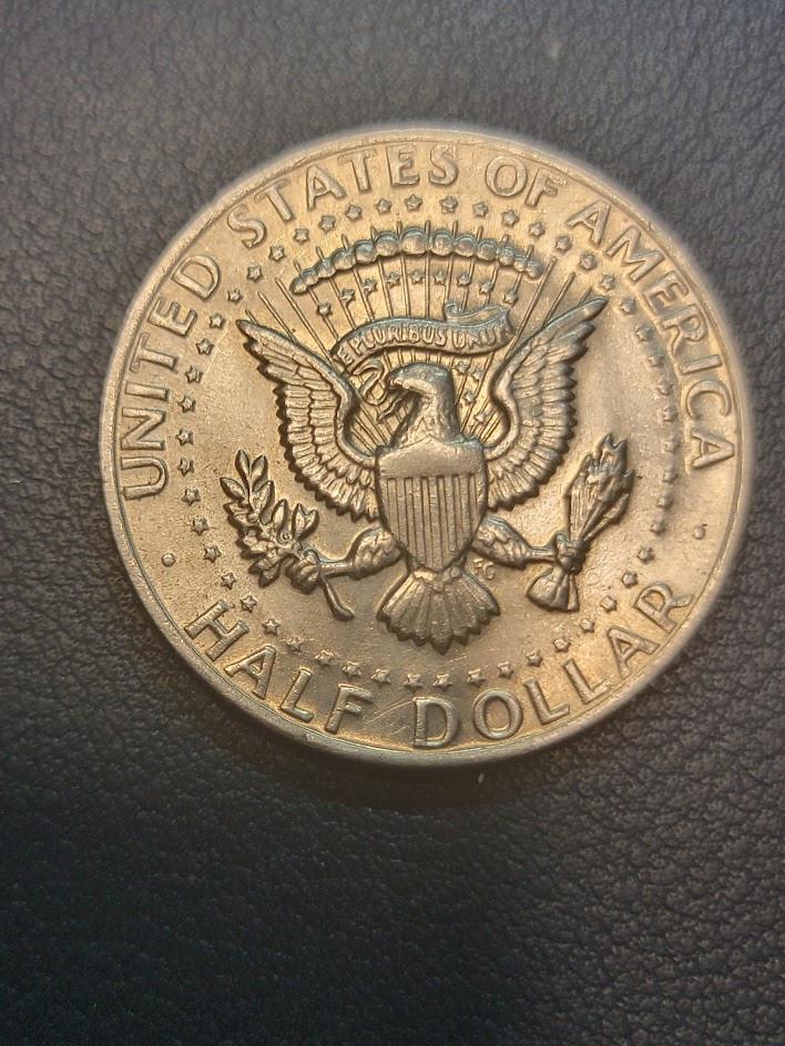 1972--Kennedy-Half-Dollar.---Doubling-In-The-Back-Side-Of-Head.