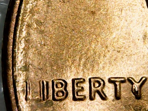Penny-With-Raised-Half-Circle-Going-Thru-In-God-We-Trust
