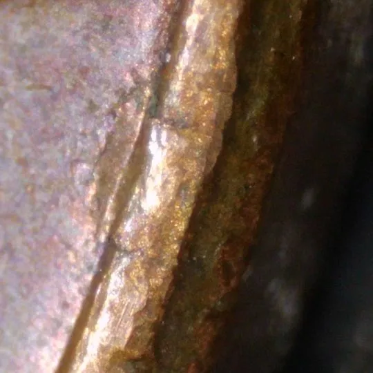1977-LMC-Penny-/-Struck-Thru-Foil.-Retained-Break,-Or-Fin-Fold-Over?