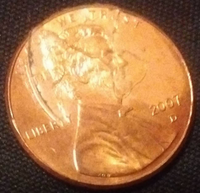 2007-Penny-Messed-Up-Looking-Is-This-From-Glue-Or-Some-Kind-Of-Other-Damage